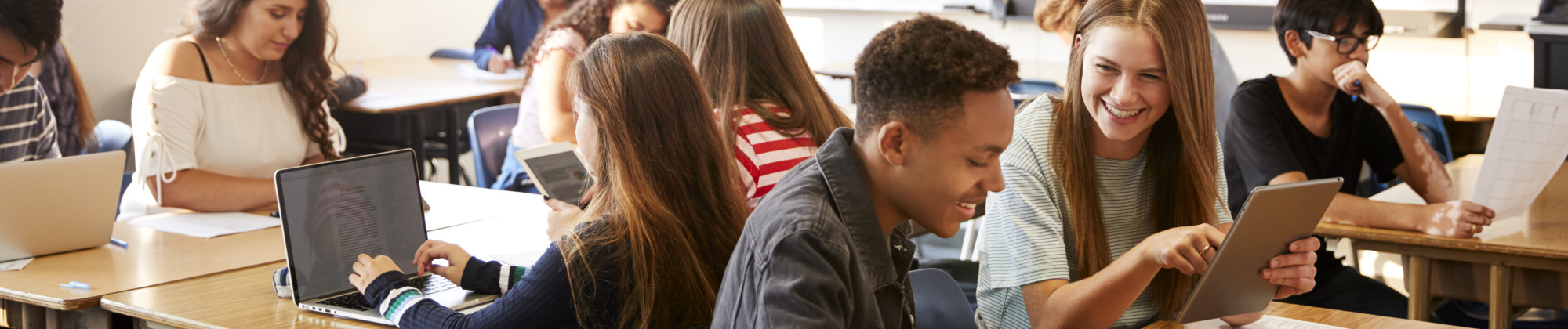 High school students at desks grouped in four