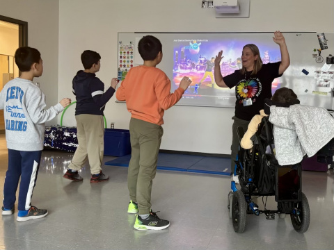 Jennifer Landry-Reid leads a scheduled movement break to help her students regulate and transition after recess at West Bedford School.