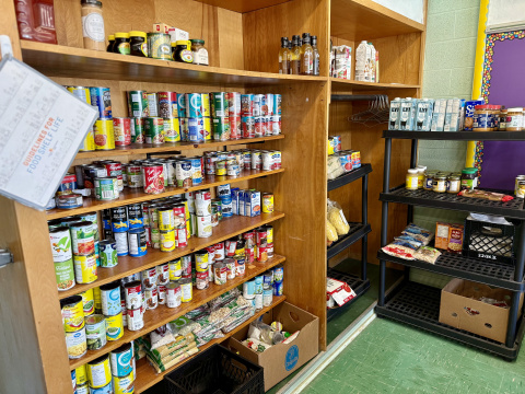 Canned goods on shelves in the BFEC food market.