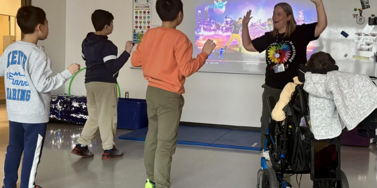 Jennifer Landry-Reid leads a scheduled movement break to help her students regulate and transition after recess at West Bedford School.